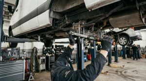 Mechanic servicing commercial van diesel engine with DPF regeneration and DEF system